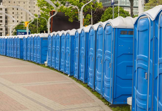 a row of portable restrooms set up for a large athletic event, allowing participants and spectators to easily take care of their needs in Anderson Island